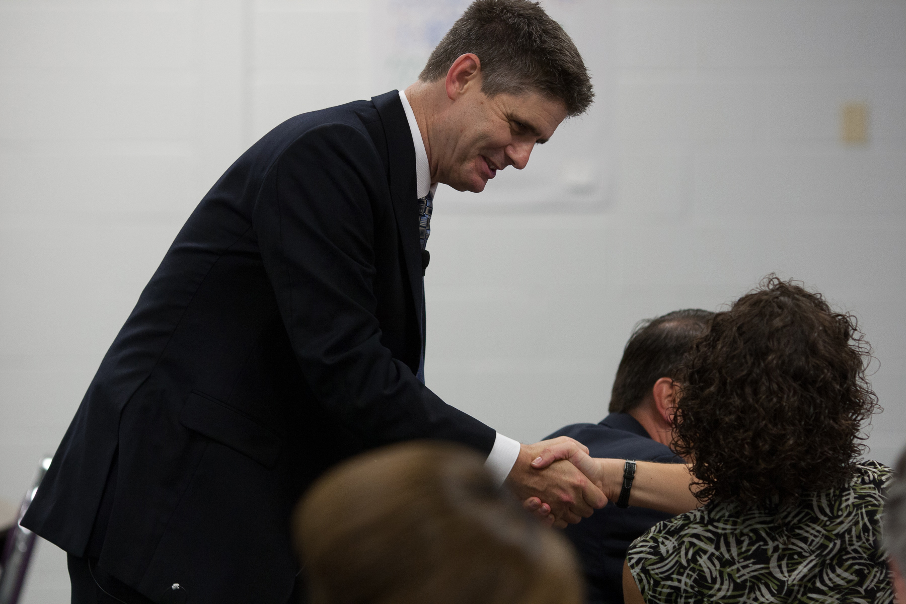 man shaking hands with woman